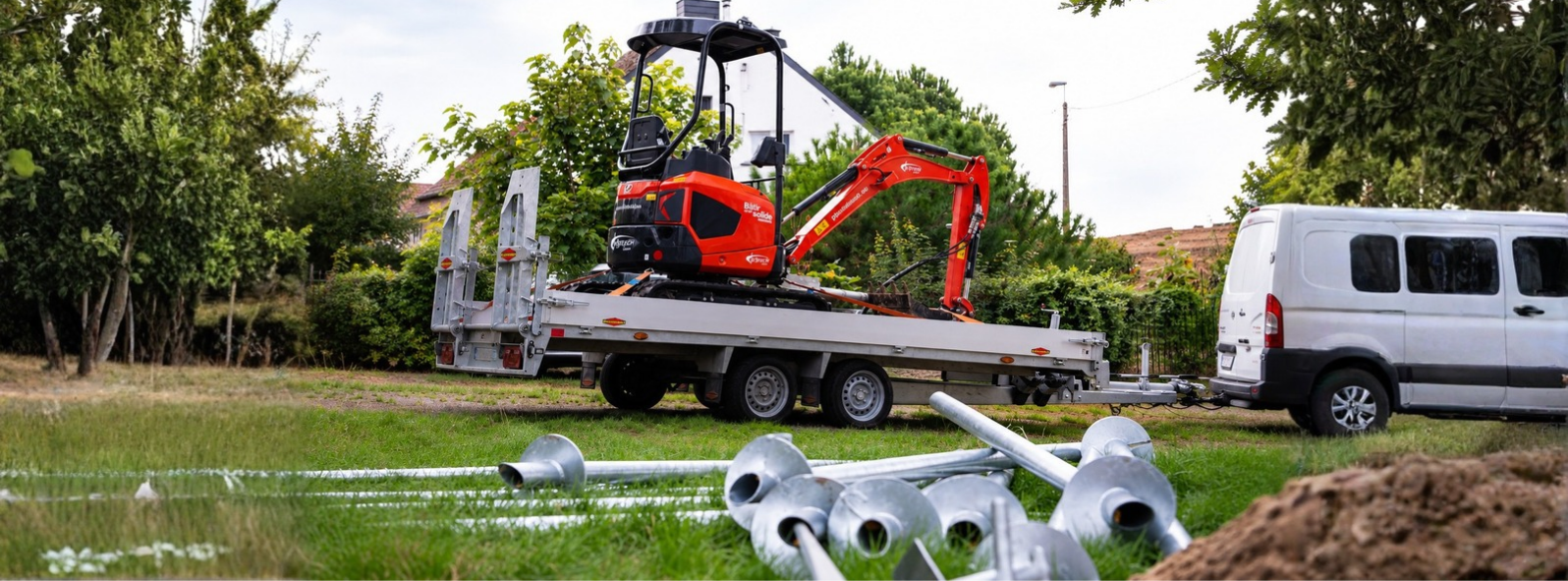 Foundation piles and an excavator for driving foundation screws 